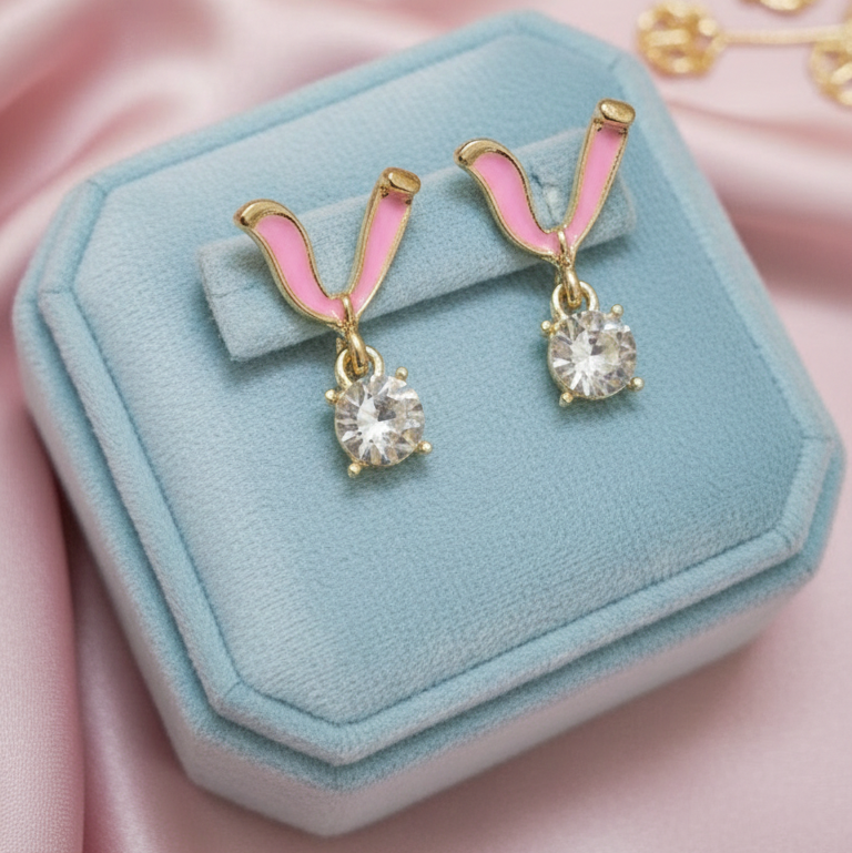 Gold earrings in pink shade with white stone